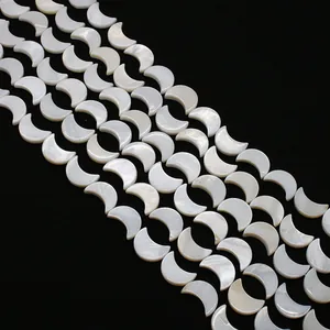 Macro detail of crescent moon shell beads with natural iridescent white mother of pearl luster