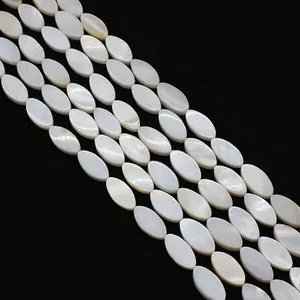 Close-up of natural white mother of pearl oval beads for DIY jewelry making