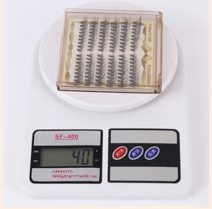 Detailed view of individual lash extensions set in gold tray for accurate weight display