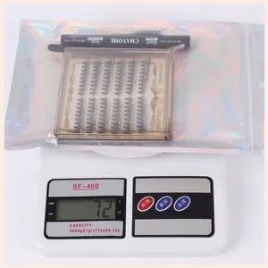 Detailed view of individual lash cluster extension kit on scale showing weight at 72 grams