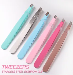 Macro detail of multi-color stainless steel eyelash tweezers with slanted tips and protective caps