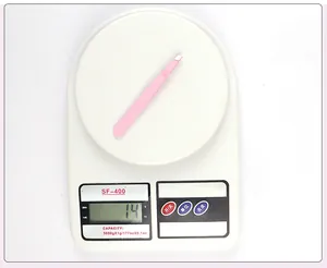 Pink stainless steel lash tweezers weighing 14 grams on a white digital scale
