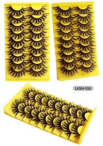 Makro-Detail von 9 Paar dicken 3D-Faux-Mink-Wimpern auf leuchtend gelben Display-Tabletts