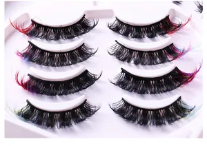 Detail view of 3D layered false eyelashes with colorful accents on a white tray