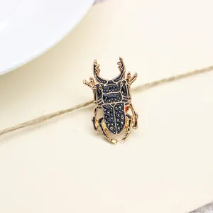 Exquisite beetle shaped brooch in gold finish with black enamel texture on vintage card