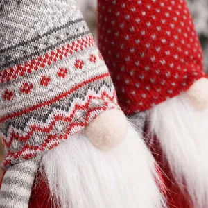 Close-up of knit Christmas gnome with snowflake patterns and plush white beard texture