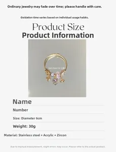 Close-up of gold beaded bracelet featuring pink heart charms and sparkling cubic zirconia