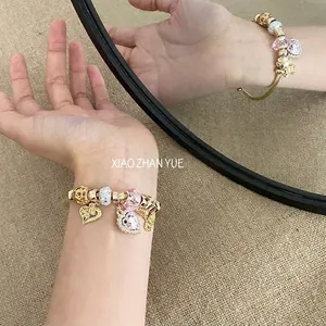 Golden snake chain bracelet with pink heart crystal charm and sparkling beads for women