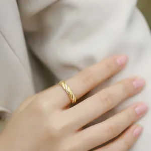 Brushed gold Mobius ring with pave cubic zirconia in a modern minimalist style