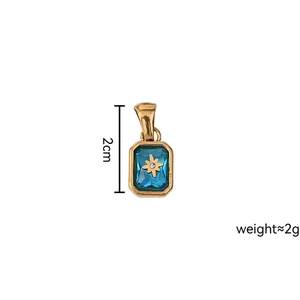 Detail of 18K gold plated birthstone pendant with blue zircon and star pattern
