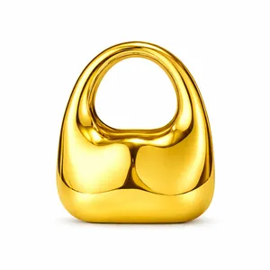 Polished gold acrylic handbag featuring a smooth sculptural shape and mirrored finish