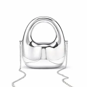 Close-up of a silver mirror finish mini bag with metallic chain and oval top handle