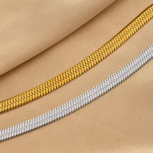Close-up of gold and silver stainless steel flat herringbone chains with mirror finish