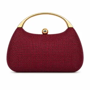 Detail of red woven evening clutch bag with elegant golden curved metal handles