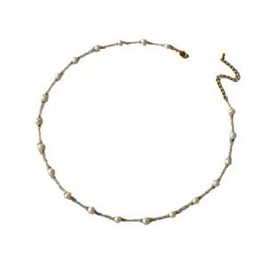 Elegant gold-plated brass necklace with spaced freshwater pearls on a delicate chain