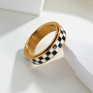 Classic stainless steel spinner ring with black and white checkerboard enamel design