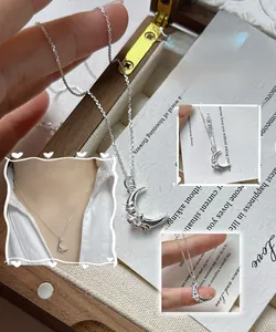 Detailed view of S925 sterling silver crescent moon necklace with ribbon bow texture