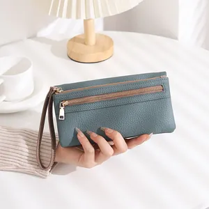 Detailed close-up of a long lychee texture wallet in grey-blue with gold double zippers
