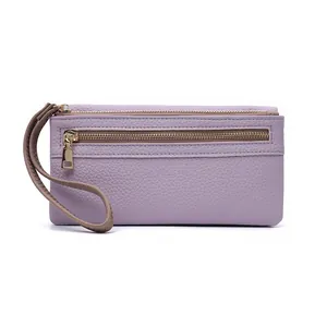 Detail of purple litchi grain leather wallet with dual gold zippers and wrist strap