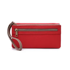 Detail of red pebbled leather long wallet featuring double gold zippers and wristlet strap