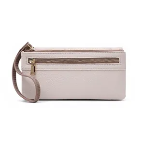 Detail view of beige lychee grain leather wallet with double zippers and wrist strap