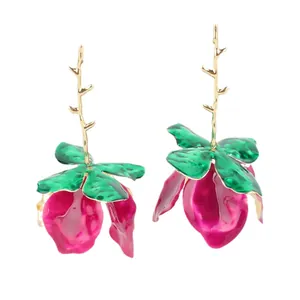 Artistic gold branch earrings with green leaves and magenta enamel flower petals