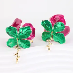 Exaggerated metal flower earrings with green clover enamel and magenta pleated petals