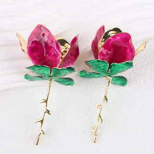 Detail of fuchsia enamel rose earrings with gold plated branch design in macro view