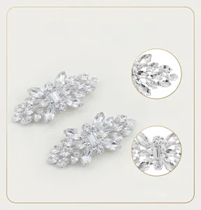 Detailed view of sparkling leaf-shaped rhinestone shoe clips with copper claw base.