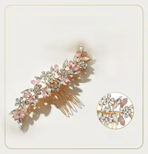 Close-up of pink marquise rhinestones and golden alloy finish on a floral hair comb