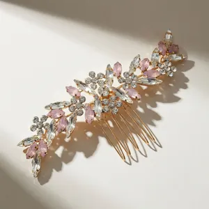 Elegant gold bridal hair comb with pink marquise rhinestones and leaf-shaped crystals