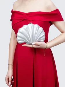 Chic pearl shell evening clutch bag held by a model in a formal red dress
