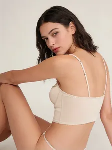 Detail view of beige satin bralette featuring delicate lace trim and thin straps for women
