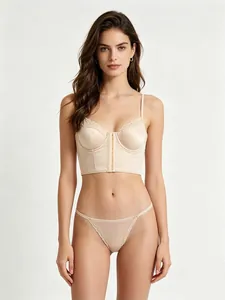 Détail d'un bustier en satin champagne avec dentelle et son string assorti