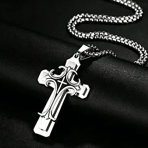 Detailed macro of layered stainless steel cross pendant with filigree on black leather