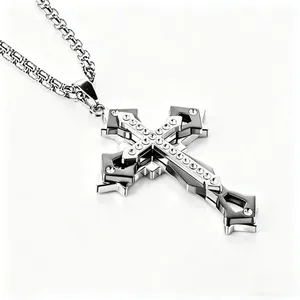 Detailed close-up of triple-layered silver cross pendant with sparkling zircon stones