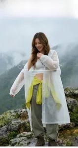 Translucent white EVA raincoat with hood and elastic cuffs in outdoor rainy mountain setting