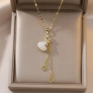 Elegant gold-plated necklace with white heart pendant and dual tassel chain in a gift box