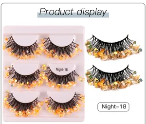 Detail view of Night-18 false eyelashes with golden and orange iridescent sequins on tips