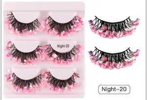 Macro shot of 3 pairs of voluminous pink sequin eyelashes with purple glitter accents