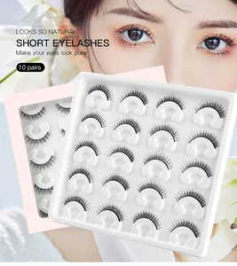 Detail view of 10 pairs of short natural false eyelashes on a white tray for daily makeup