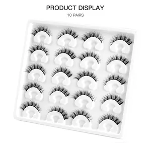 Top view of 10 pairs of dense natural black false eyelashes in a white plastic tray