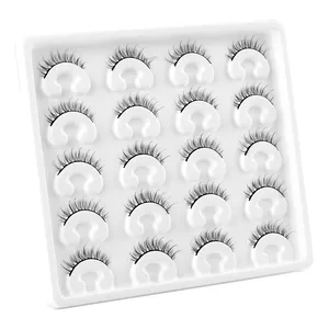 20 pairs of natural thick faux mink eyelashes set on a white professional display tray