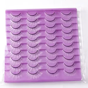 Detailed view of 20 pairs of dramatic white false eyelashes on a purple plastic tray