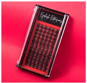 Close-up of DIY cluster eyelash extensions in a clear box with red textured background