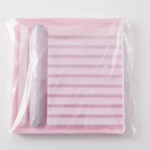 Detailed view of pink DIY eyelash extension tray and applicator tools in secure packaging