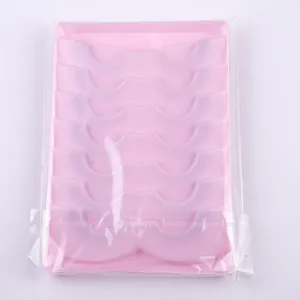 Detailed view of 7 pairs of fox-eye false eyelashes with elongated ends in pink tray