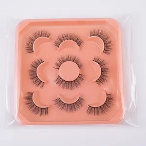 Close-up of 7 pairs of thick curly black faux mink eyelashes in a pink square tray