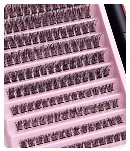 Macro detail of individual cluster eyelashes in pink tray for DIY lash extension kit