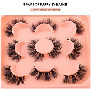 Close-up of 5 pairs of fluffy faux mink eyelashes displayed on a pink tray